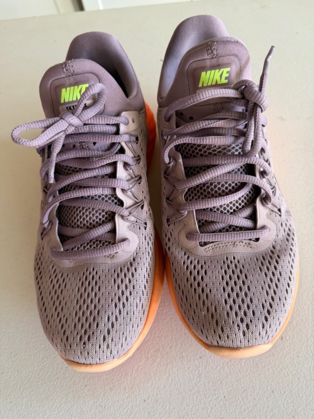 Nike Woman’s Athletic Shoes in Mauve with Orange Sole.Comfortable
